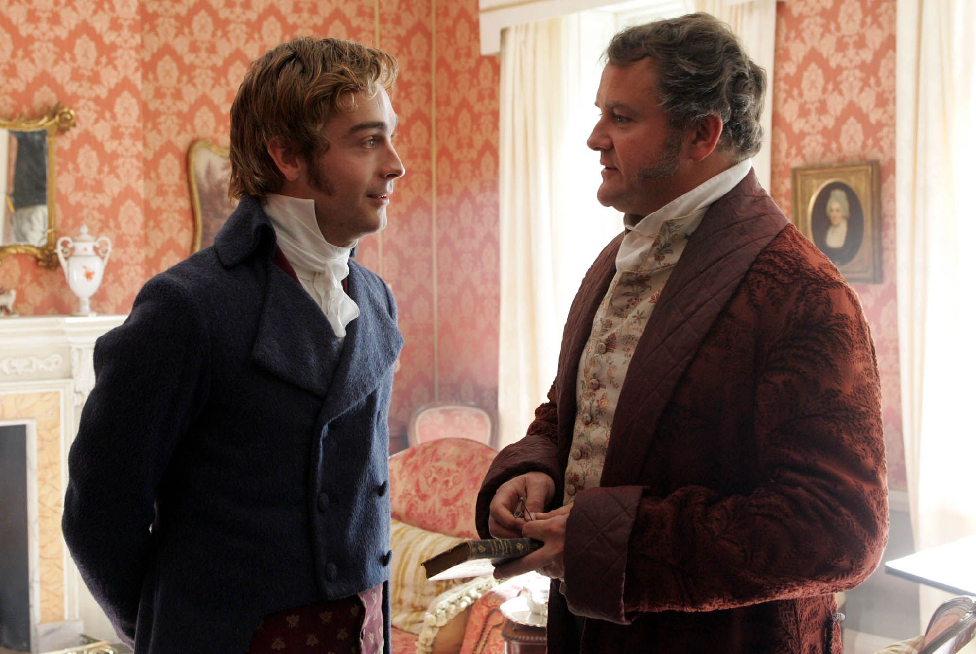 Tom Mison as Charles Bingley, speaks with Hugh Bonneville as Mr. Bennet, in Lost in Austen